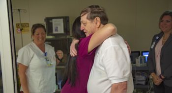 Bryan England hugs one of the caregivers that helped save his life