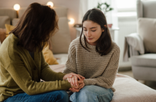 Teenage girl sharing problems with her mother in the room.