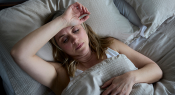 Menopausal Mature Woman Suffering With Insomnia In Bed At Home