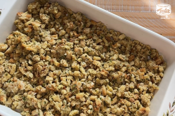 Stuffing spread on the bottom of a casserole dish